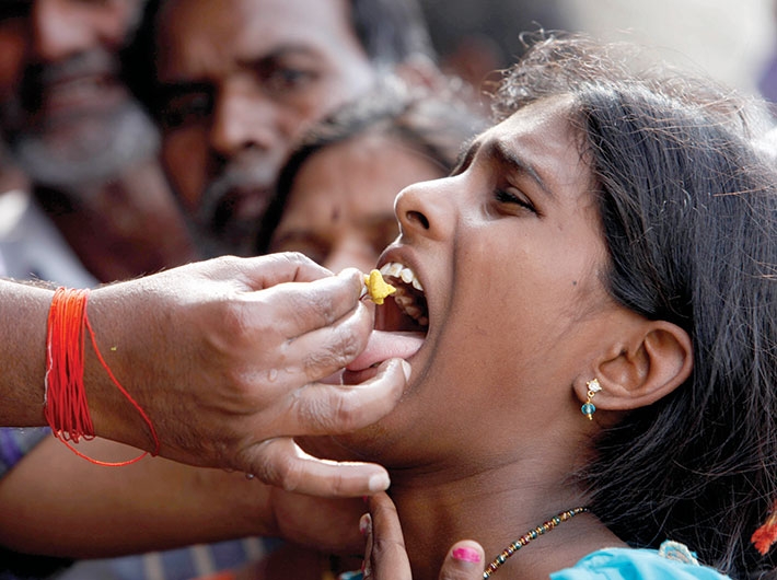 A woman gets the fish prasadam during the event, held on June 8-9.