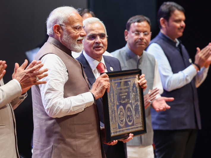 Prime minister Narendra Modi releasing the commemorative coin during the opening ceremony of RBI@90 in Mumbai on Monday