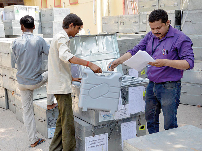 A polling official cheks and tallies the EVMs. Representational photo