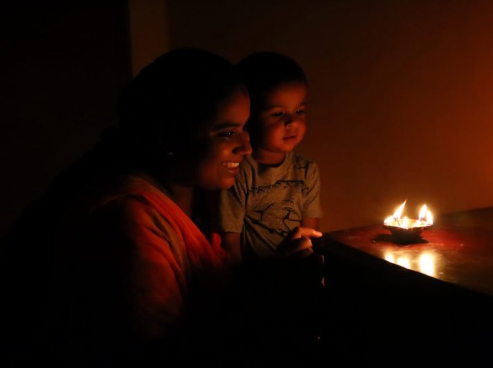A family lighting lamps last month as a collective gesture of India`s fight against Covid-19.