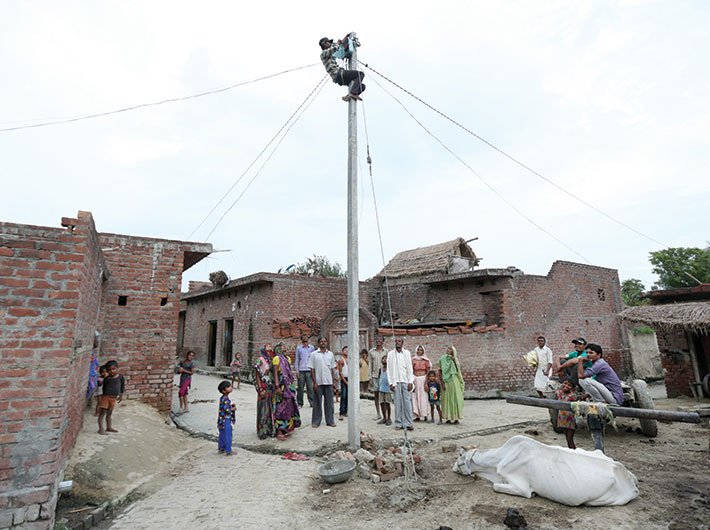 An electricity pole being set up at a village in Uttar Pradesh’s Badaun district