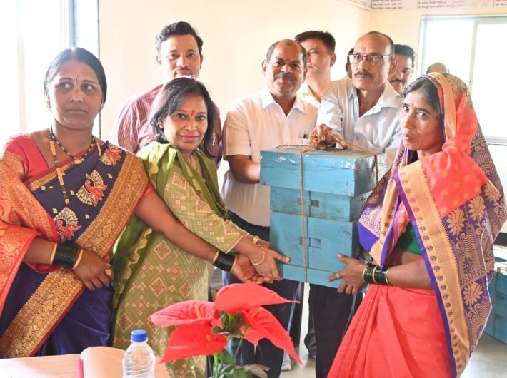 Maharashtra KVIB CEO Anshu Sinha distributes bee boxes to farmers in Manghar village.