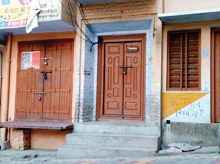 ‘House for sale’ sign painted on a house in Kairana