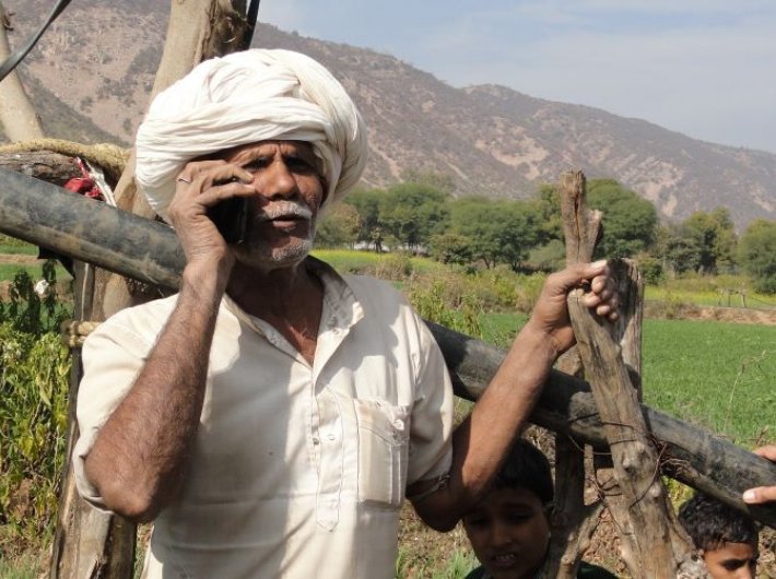 A villager listening to the relevant information on his mobile through ICT interventions (Photo courtesy: S M Sehgal Foundation)