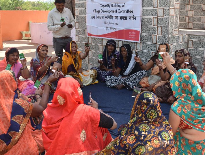 A capacity building session of Village Development Committee members in progress at Nuh, Haryana (Photo courtesy S M Sehgal Foundation)