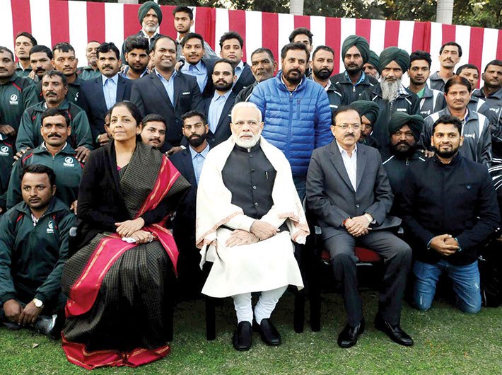 Defence minister Nirmala Sitharaman and PM Narendra Modi with NCC cadets, NSS volunteers, tableaux artists and tribal guests, in New Delhi in January