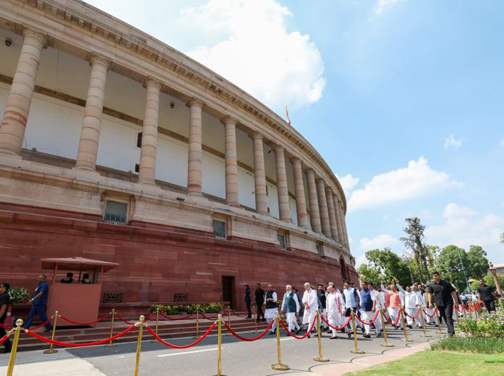 PM Narendra Modi and other dignitaries walk from the old building of Parliament to the new building on Tuesday